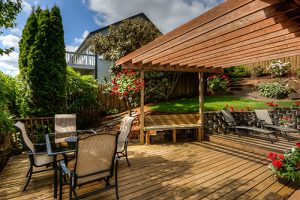 The backyard of a home with an expensive deck